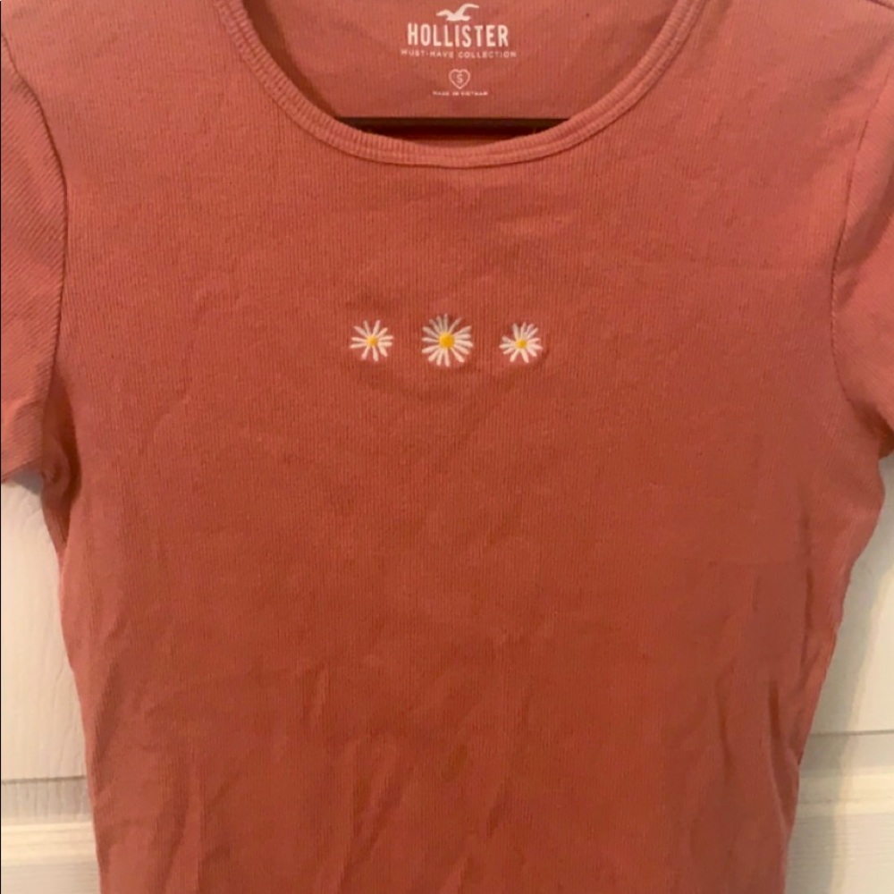 This is an older style from Hollister. It has a wavy bottom edge.